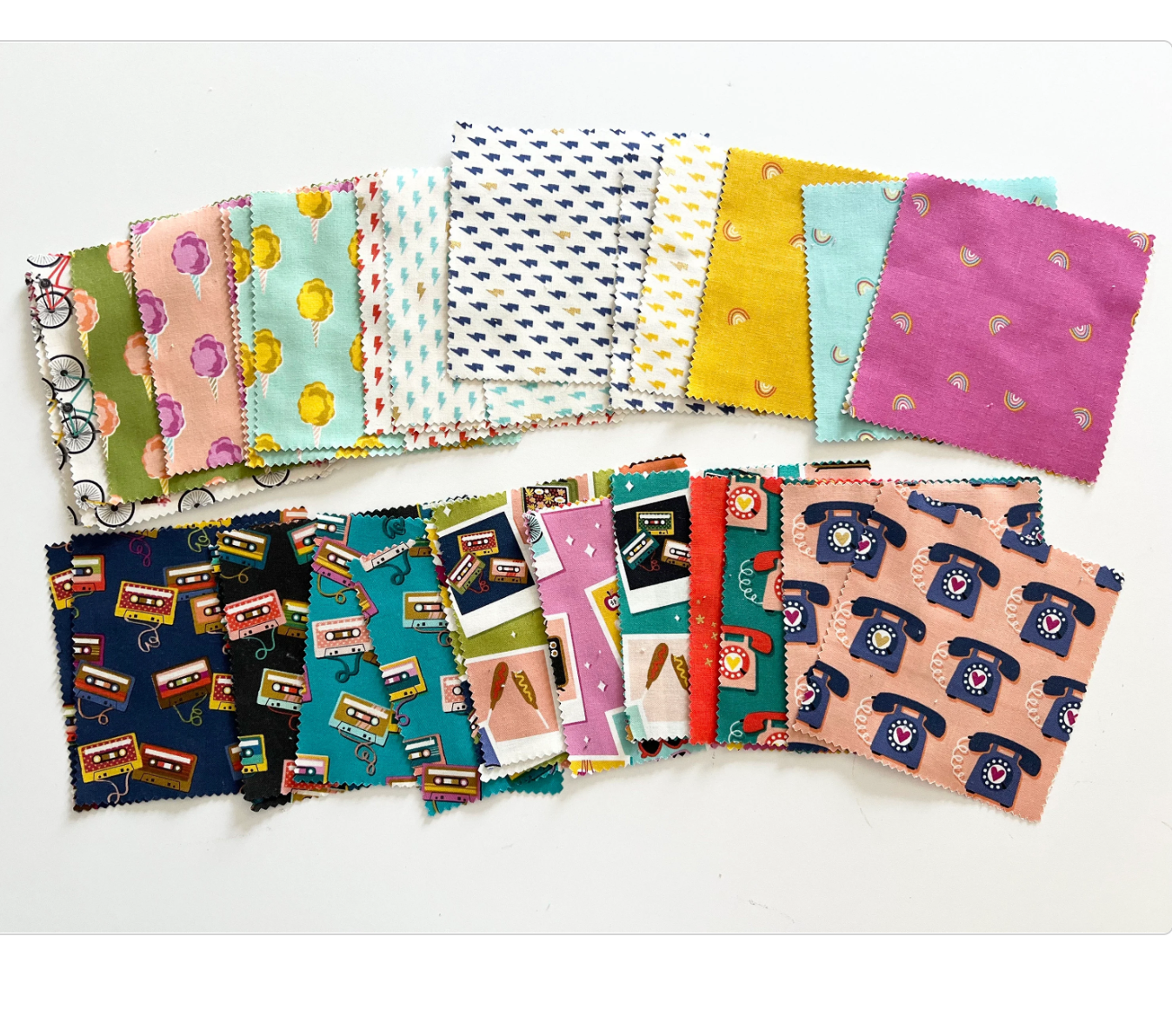 fabric with polaroids, cassette tapes, rotary phones, bicycles, cotton candy, and lightening bolts