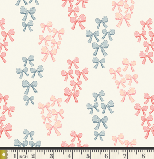 Pattern of pink and blue bows on a white background with a ruler at the bottom.